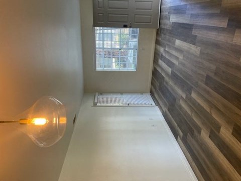 a hallway with a glass lamp and a window